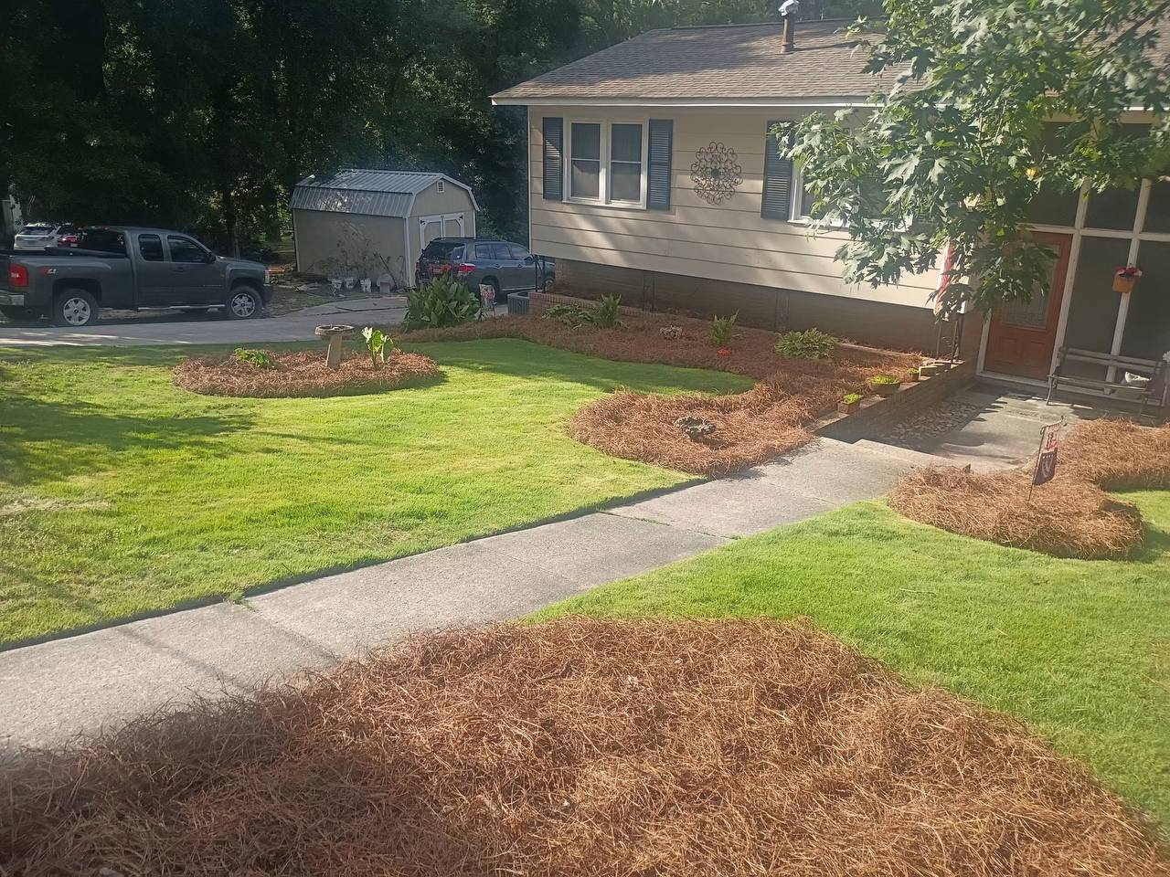 Freshly mulched front yard with vivid green lawn